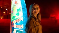 woman standing against a light installation